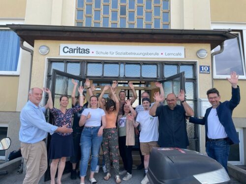 Hereinspaziert: Schuldirektor Wilfried Hude (li) und Caritasdirektor Ernst Sandriesser (re) – am Foto mit den Studierenden der Abend-SOB – bitten ab Herbst in die Tagesschule.<br />
Foto: Caritas